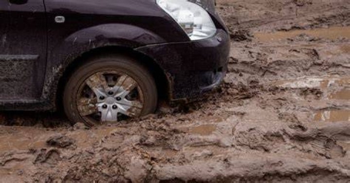 A car is stuck in the mudflats of the Manukau Habour near Bottletop Bay, Karaka.