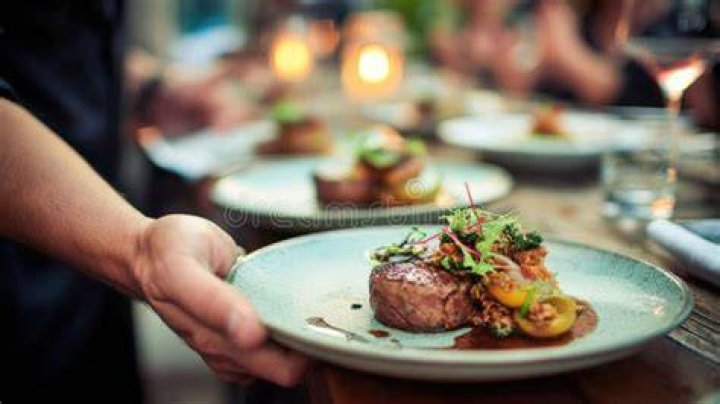 A waiter delivers a gourmet meal