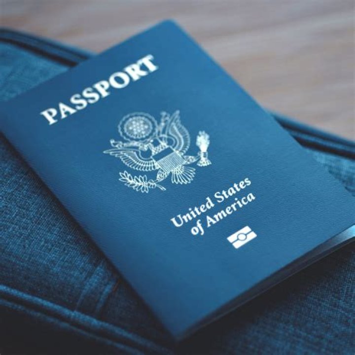 american passport sitting on a plain wooden surface