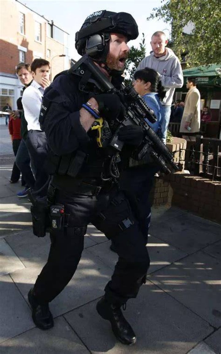 Armed police close to Parsons Green station in west London. Photo / AP