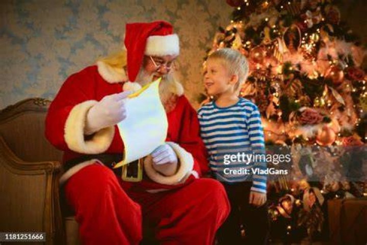 Baby Jay Santa gives a girl a present