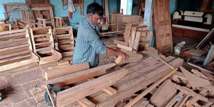 Carpenter working with a traditional rasp tool