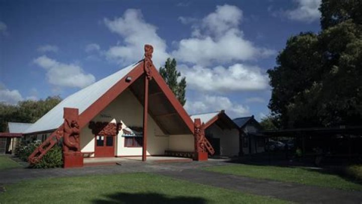 Charlie Jones, of Papakura Marae, takes down the details of a family waiting for a food parcel. Photo / Julia Gabel