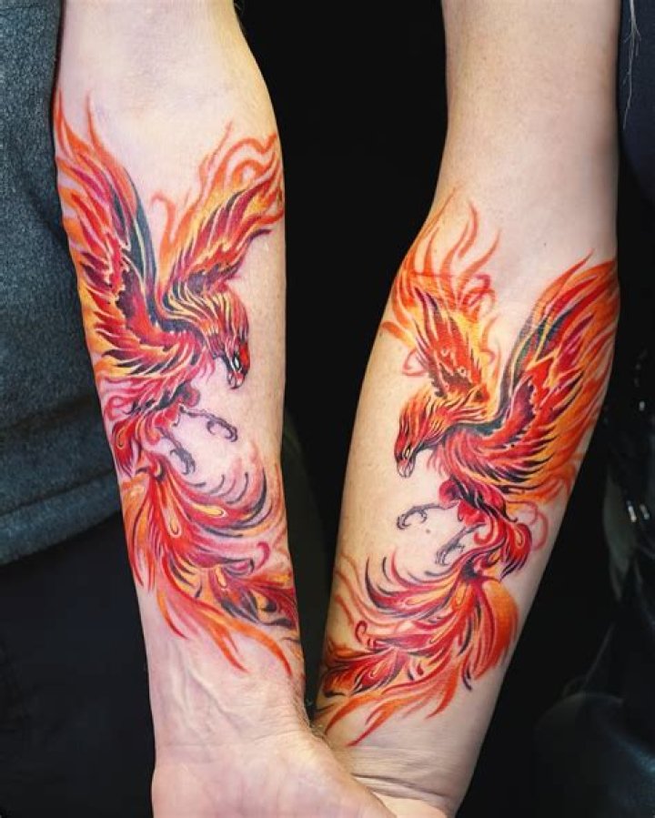Forearm phoenix tattoo with coloured ends Forearm phoenix tattoo with coloured ends