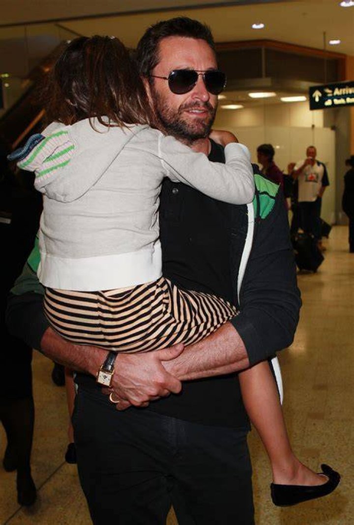 Hugh Jackman carries his daughter Ava Eliot Jackman while walking