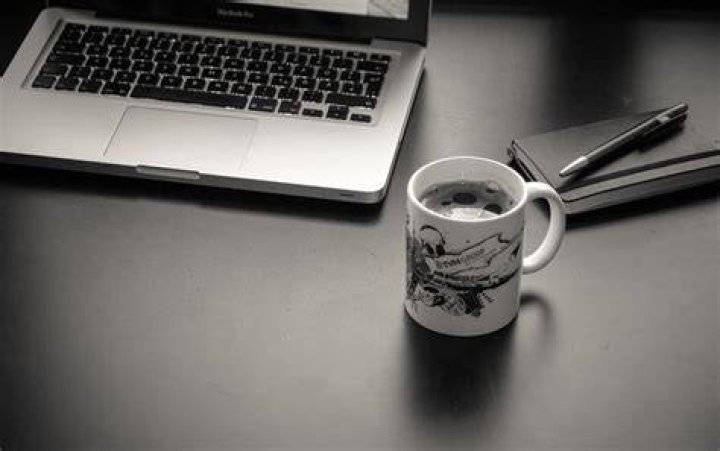 laptop and coffee cup on a cafe table