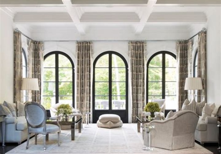 Living room with arched window and built-in shelves