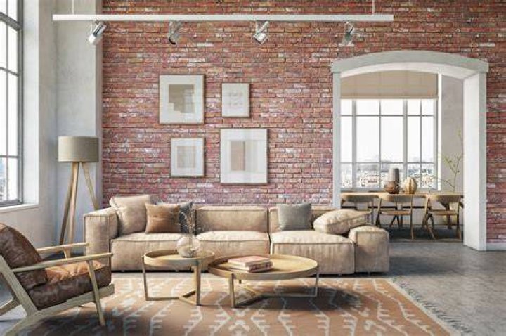 Living room with exposed brick wall and oversized windows