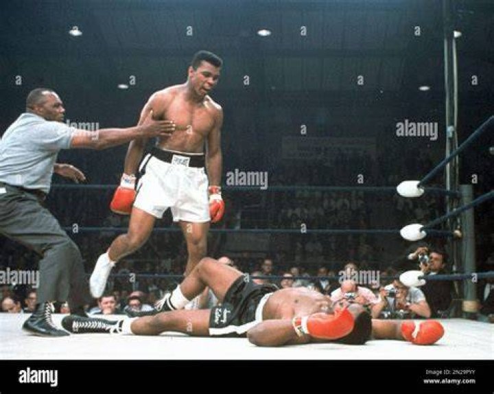 Muhammad Ali is held back by referee Joe Walcott after he knocked out challenger Sonny Liston in the first round of their title fight in Lewiston, Maine in 1965. Photo / AP