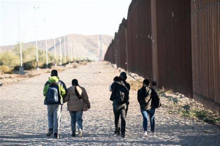 People walk toward the border crossing at Verkhny Lars between Georgia and Russia, leaving North Ossetia-Alania Republic on Wednesday. Photo / AP 