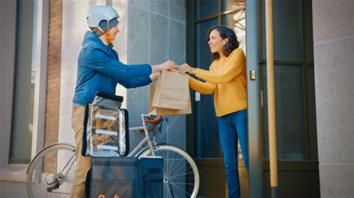 person being delivered food at their table in a restaurant