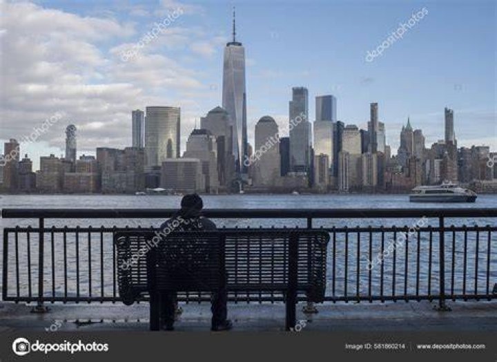 person sitting on barrier overlooking venice canal