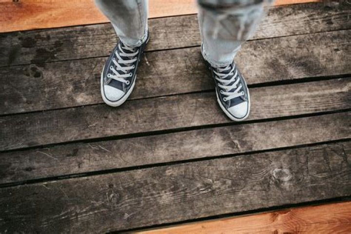 person standing on wooden planks