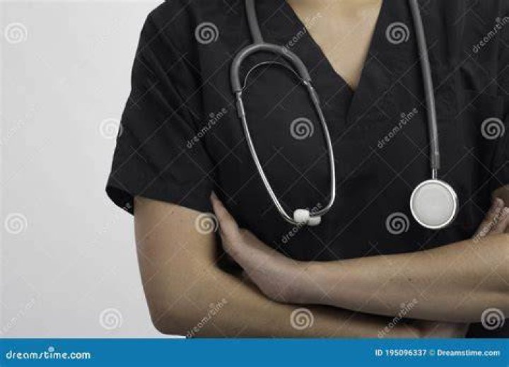 person with stethoscope on neck holding phone