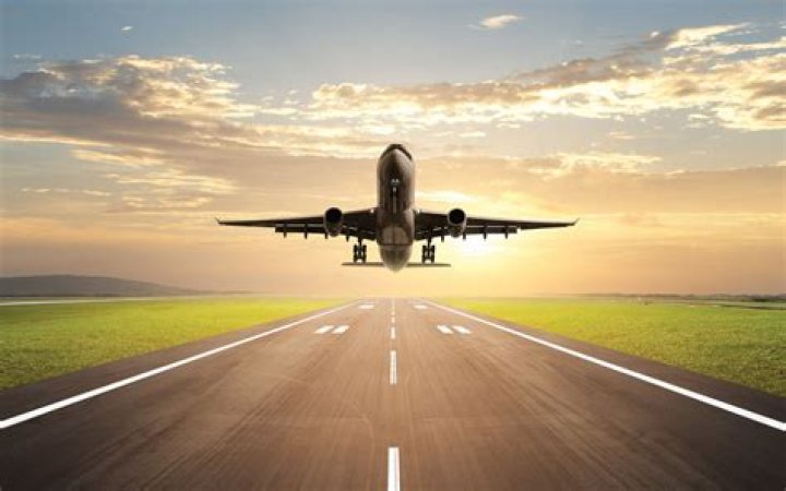 Plane taking off in an orange sky