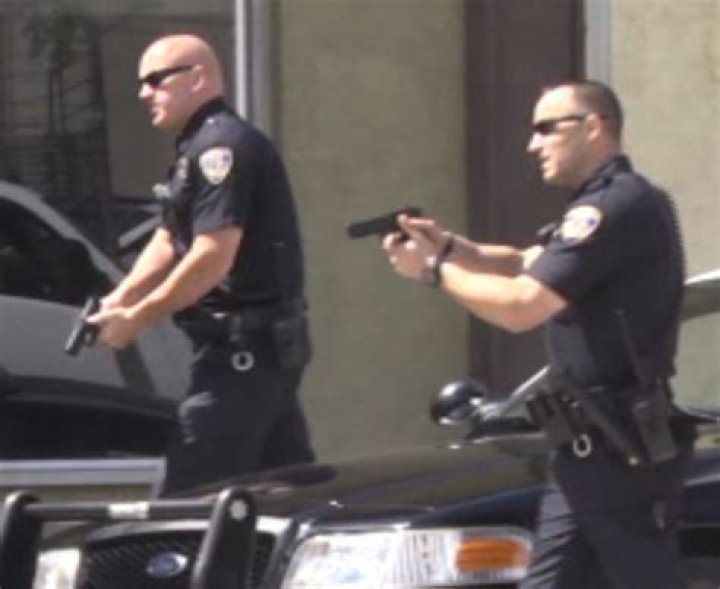 Police with guns drawn watch as protesters try to break into the House Chamber at the US Capitol. Photo / AP 