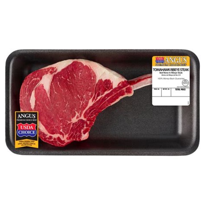 Raw Black Angus beef tomahawk steaks on bones. Raw Black Angus beef tomahawk steaks on bones.
