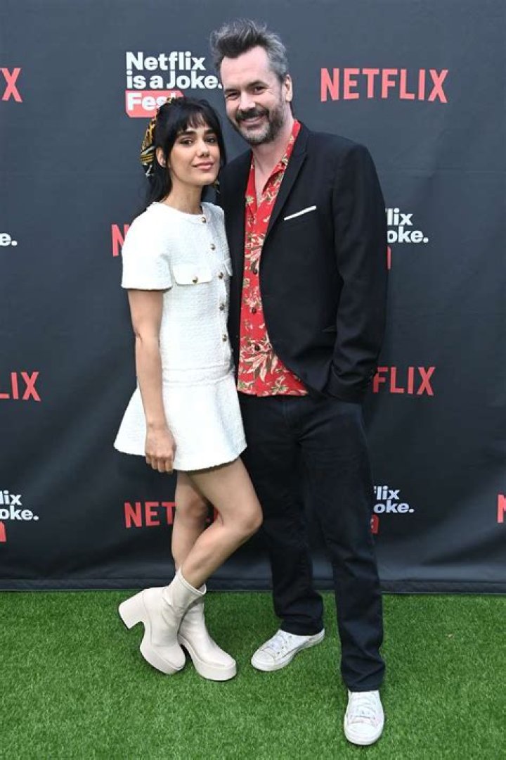 Tasie Lawrence and Jim Jefferies attending Once Upon a Time in Hollywood film premiere (L). Tasie posing for the camera (R) Tasie Lawrence and Jim Jefferies attending Once Upon a Time in Hollywood film premiere (L). Tasie posing for the camera (R)