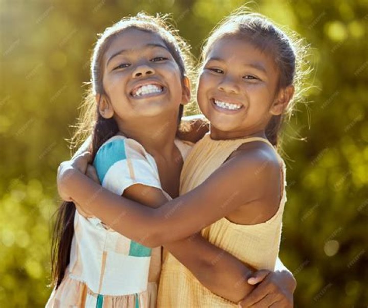 The little girl tried hugging and kissing the kid as she tried The little girl tried hugging and kissing the kid as she tried