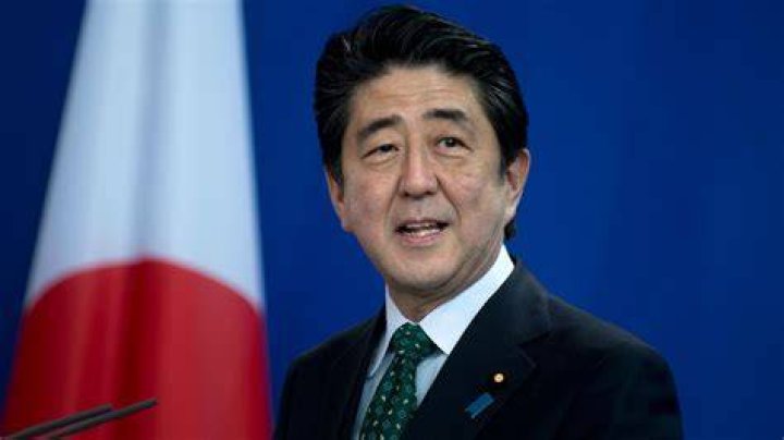 Then Japanese Prime Minister Shinzo Abe follows a Shinto priest to pay respect for the war dead at Yasukuni Shrine in Tokyo in 2013. Photo / AP