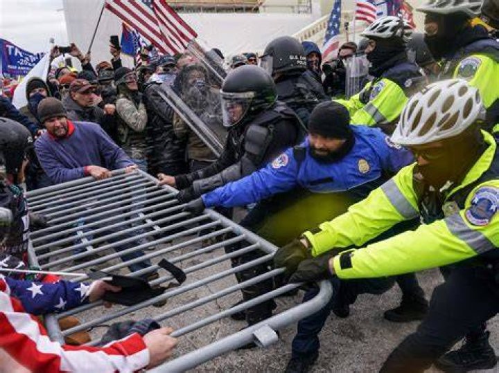 Trump supporters try to break through a police barrier on Wednesday at the Capitol in Washington. Photo / AP 
