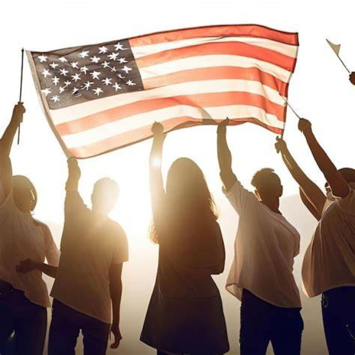 two people holding up american passports