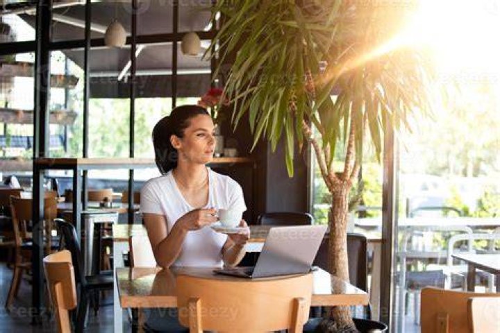 Woman in cafe on laptop