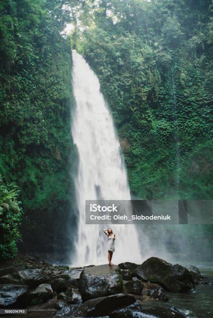 Woman standing near a waterfall
