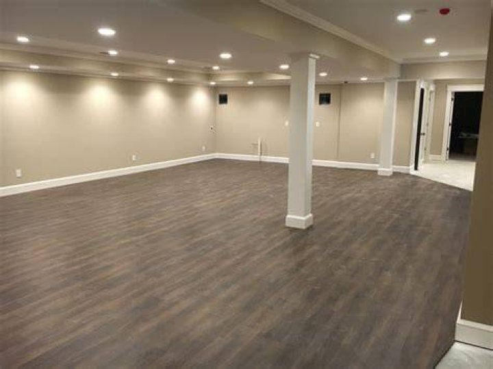 Wood flooring in basement rec room area with a lot of space